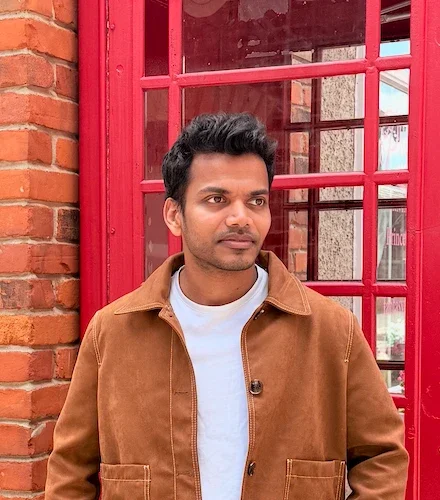 Jeril Johnson standing in front of a red telephone box